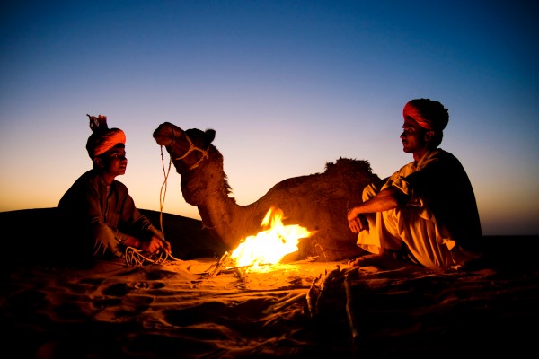 indian-men-resting-by-bonfire-with-their-camel (1)